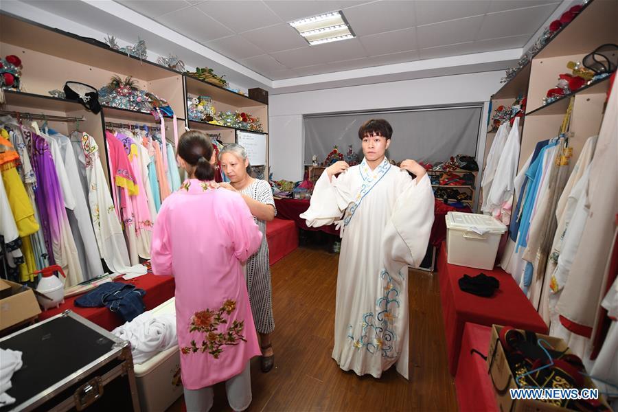 Wang Hongyuan (R) changes clothes before performing at Shengzhou Yue Opera art school in Shengzhou, east China\'s Zhejiang Province, Sept. 3, 2018. Wang Hongyuan, 17, was born in Taizhou of Zhejiang Province. He is the only male student who learns playing Xiaosheng (role of young man) in Yue Opera at Shengzhou Yue Opera art school. Xiaosheng are usually played by female actresses in Yue Opera which is an old art form originated in Shengzhou and noted for its lyricism and sweet tunes in China. Wang Hongyuan was granted special admission on account of his talent and resolve when he was at second grade in junior middle school. After hard practices, he has already taken part in some performances. (Xinhua/Weng Xinyang)