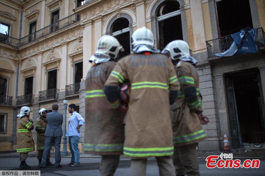 Firefighters and Federal Police members talk in front of Rio de Janeiro\'s treasured National Museum, one of Brazil\'s oldest, on September 3, 2018, two days after a massive fire ripped through the building. 
Brazilian officials on Monday blamed years of government cutbacks for an inferno that gutted the treasured National Museum, described by President Michel Temer as a \