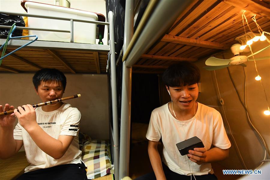 Wang Hongyuan (R) practices singing Yue opera at his dormitory at Shengzhou Yue Opera art school in Shengzhou, east China\'s Zhejiang Province, Sept. 3, 2018. Wang Hongyuan, 17, was born in Taizhou of Zhejiang Province. He is the only male student who learns playing Xiaosheng (role of young man) in Yue Opera at Shengzhou Yue Opera art school. Xiaosheng are usually played by female actresses in Yue Opera which is an old art form originated in Shengzhou and noted for its lyricism and sweet tunes in China. Wang Hongyuan was granted special admission on account of his talent and resolve when he was at second grade in junior middle school. After hard practices, he has already taken part in some performances. (Xinhua/Weng Xinyang)