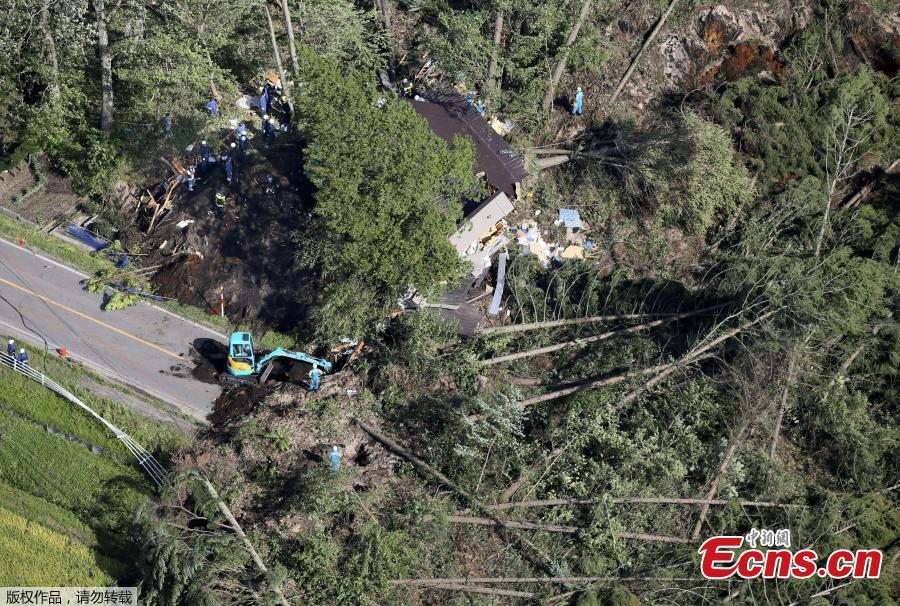 Police officers and rescue workers search for survivors from a building damaged by a landslide caused by a powerful earthquake in Atsuma town in Japan\'s northern island of Hokkaido, Japan, in this photo taken by Kyodo September 6, 2018.