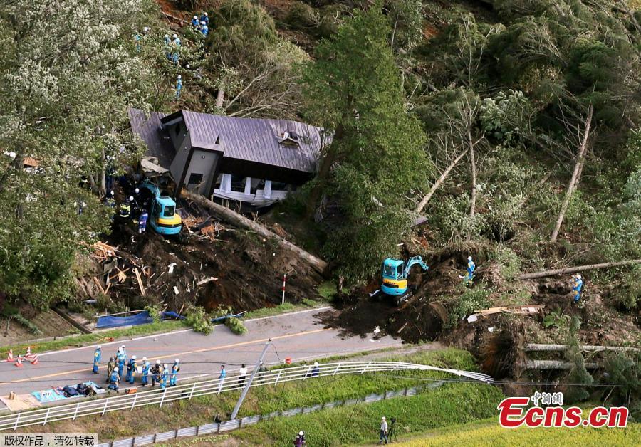 Police officers and rescue workers search for survivors from a building damaged by a landslide caused by a powerful earthquake in Atsuma town in Japan\'s northern island of Hokkaido, Japan, in this photo taken by Kyodo September 6, 2018.