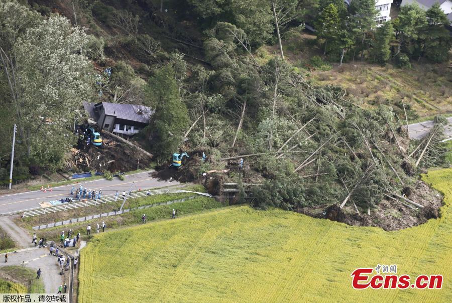 Police officers and rescue workers search for survivors from a building damaged by a landslide caused by a powerful earthquake in Atsuma town in Japan\'s northern island of Hokkaido, Japan, in this photo taken by Kyodo September 6, 2018.