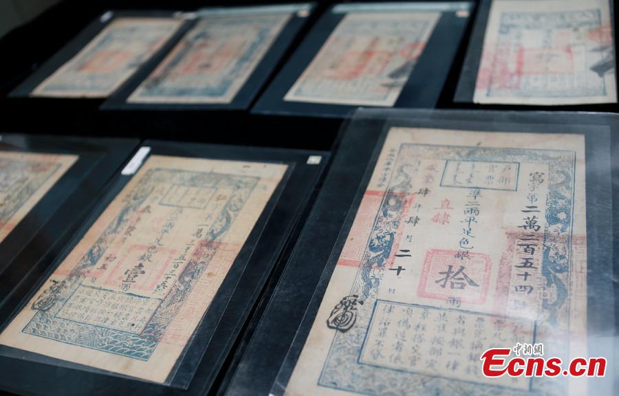 Customs officials show relics found in border checks at a handover ceremony in Guangdong Province, Sept. 6, 2018. Gongbei Customs handed over 157 cultural relics, including currency from the Warring States (475-221 B.C.) and Han Dynasty (206 BC ? 220 AD) periods, to Guangdong Provincial Cultural Relics Bureau. The relics were all Class I items under state protection and forbidden to be taken abroad. Among the findings was a well-preserved account book of the Qing Dynasty (1368-1644), thought to be of great historical value. (Photo: China News Service/Yu Bo)