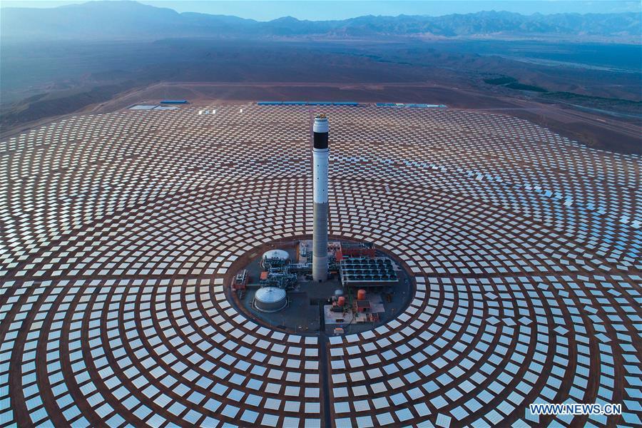 Photo provided by Shandong Electric Power Construction Co., Ltd (SEPCO III) shows part of Morocco\'s NOOR III Concentrated Solar Power (CSP) project in Ouarzazate, Morocco, on June 7, 2018. (Xinhua)
Driving from Rabat, capital of Morocco, all the way south over the Atlas Mountains, it took eight hours to reach the city of Ouarzazate, the gateway of the Sahara Desert.
Looking north from the downtown, a tower measuring 248 meters high shines in the sun. It is the tallest solar tower in the world, which is built by a Chinese construction company as part of Morocco\'s Noor III Concentrated Solar Power (CSP) project.
In order to reduce dependence on energy imports, the Moroccan government has been actively developing renewable energy, and plans to raise the proportion of renewable energy to the total energy consumption to 42 percent by 2020.
Under the Belt and Road Initiative proposed by China in 2013, Chinese builders came to Morocco to provide a solid fulcrum for the energy restructuring of this North African country.
The initiative, formally known as the Silk Road Economic Belt and the 21st-Century Maritime Silk Road, aims to build a trade and infrastructure network connecting Asia with Africa and Europe along the ancient trade routes of the Silk Road.
Since 2015, Shandong Electric Power Construction Co., Ltd (SEPCO III), a subsidiary of Power Construction Corporation of China, has undertaken the construction of NOOR II and NOOR III CSP projects in Ouarzazate.
The NOOR Solar Complex, a four-phase project, is the world\'s largest CSP station under construction. The NOOR II project has already been put into commercial operation, while the NOOR III project recently achieved its first grid connection target.
After completion of all four phases of projects, the NOOR station will provide clean energy for more than 1 million Moroccan households, and even export surplus electricity to Europe.
According to the staff of the NOOR projects, the 200-MW Noor II has the world\'s largest installed capacity as a parabolic trough power plant, while the 160-MW installed capacity of the NOOR III is the largest among the world\'s tower power plants.
Zhou Hejun, project director of the NOOR III, said CSP plants are more stable and cause less damage to the power grid compared with their photovoltaic counterparts.
The CSP will be the main global trend of solar energy generation in the future, Zhou noted.
Zhao Guangjian, project director of the NOOR II, the two NOOR projects created 5,500 jobs for Moroccans during the peak period.
A total of 300 Moroccan engineers are currently in employment, while the later operation and maintenance will also largely rely on Moroccan technicians, Zhao told Xinhua.
Mohammed Said Mulani, director of a construction subcontracting company in Ouarzazate, said his enterprise has grown rapidly and acquired expertise in constructing CSP stations through participation in the NOOR II and NOOR III projects.
\