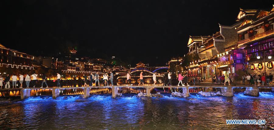 Tourists go sightseeing at Fenghuang old town in Fenghuang County, central China\'s Hunan Province, Sept. 7, 2018. Fenghuang, which means \