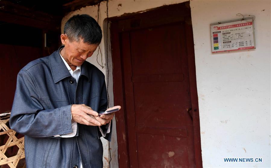 Wang Zhengxiang concerns over an absent student at Ayiyang Primary School in Sanmeng Village of Luquan Yi and Miao Autonomous County, southwest China\'s Yunnan Province, Sept. 6, 2018. One teacher, eight students, none was and will be given up thanks to rural teacher Wang Zhengxiang. Wang Zhengxiang of Miao ethnic group, 56, is the only teacher and has been teaching at the remote village primary school of Ayiyang for 38 years. Ayiyang Primary School, lying at an altitude of 2,600 meters above sea level and surrounded by mountains, is not within easy reach of outside world. There are just eight students at the school. Yet Wang takes care of his students with love, consideration and strong sense of responsibility. He buys shoes and daily goods for poverty-stricken students with his own money, and he has tried every means to keep those who wanted to drop out due to economic insufficiency. \
