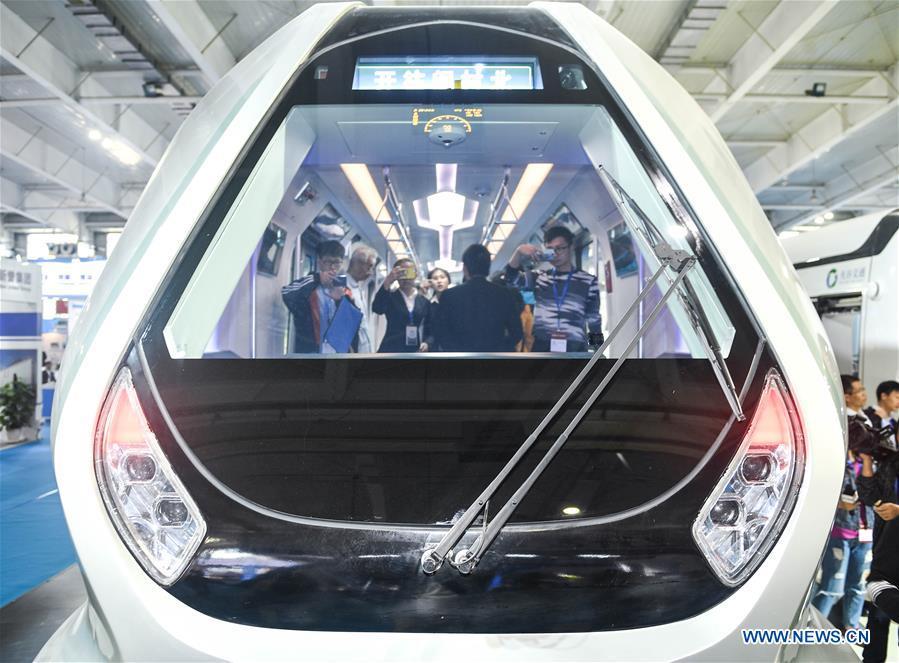 People try out a new-generation carbon-fiber light rail train at an exhibition held in Changchun, capital of northeast China\'s Jilin Province, Sept. 7, 2018. The body of the train is made of carbon fiber composite, making it more energy-efficient, according to its manufacturer CRRC Changchun Railway Vehicles Co., Ltd. (Xinhua/Xu Chang)