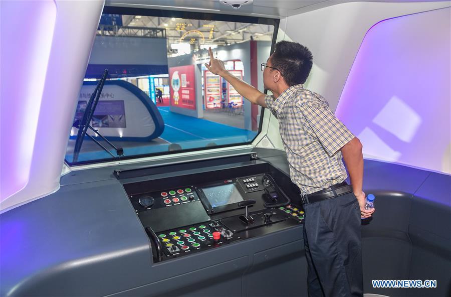 A man visits the cockpit of a new-generation carbon-fiber light rail train at an exhibition held in Changchun, capital of northeast China\'s Jilin Province, Sept. 7, 2018. The body of the train is made of carbon fiber composite, making it more energy-efficient, according to its manufacturer CRRC Changchun Railway Vehicles Co., Ltd. (Xinhua/Xu Chang)