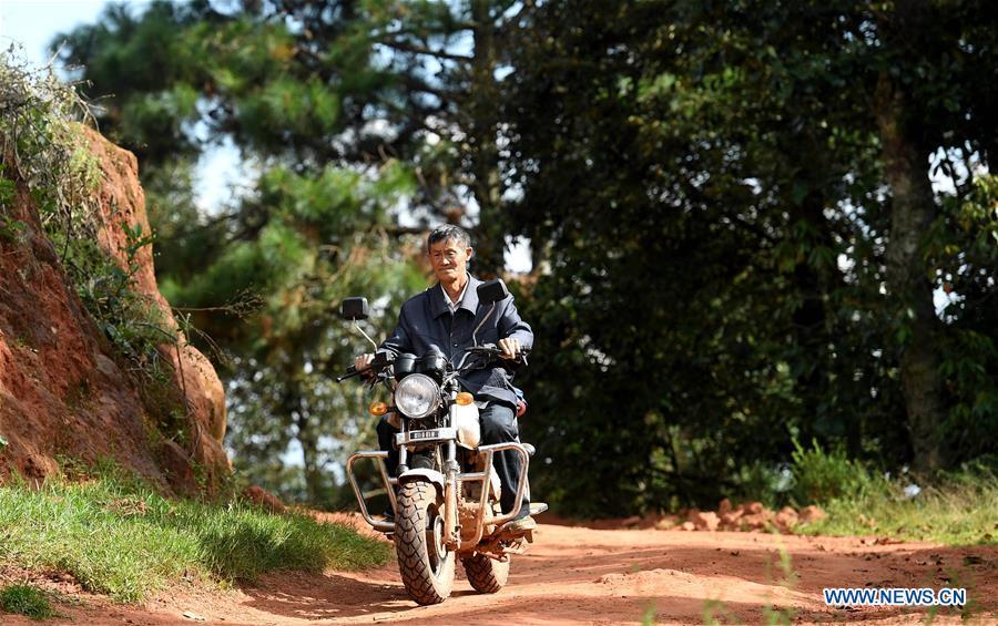 Wang Zhengxiang rides over the mountain to buy food for students in Sanmeng Village of Luquan Yi and Miao Autonomous County, southwest China\'s Yunnan Province, Sept. 5, 2018. One teacher, eight students, none was and will be given up thanks to rural teacher Wang Zhengxiang. Wang Zhengxiang of Miao ethnic group, 56, is the only teacher and has been teaching at the remote village primary school of Ayiyang for 38 years. Ayiyang Primary School, lying at an altitude of 2,600 meters above sea level and surrounded by mountains, is not within easy reach of outside world. There are just eight students at the school. Yet Wang takes care of his students with love, consideration and strong sense of responsibility. He buys shoes and daily goods for poverty-stricken students with his own money, and he has tried every means to keep those who wanted to drop out due to economic insufficiency. \
