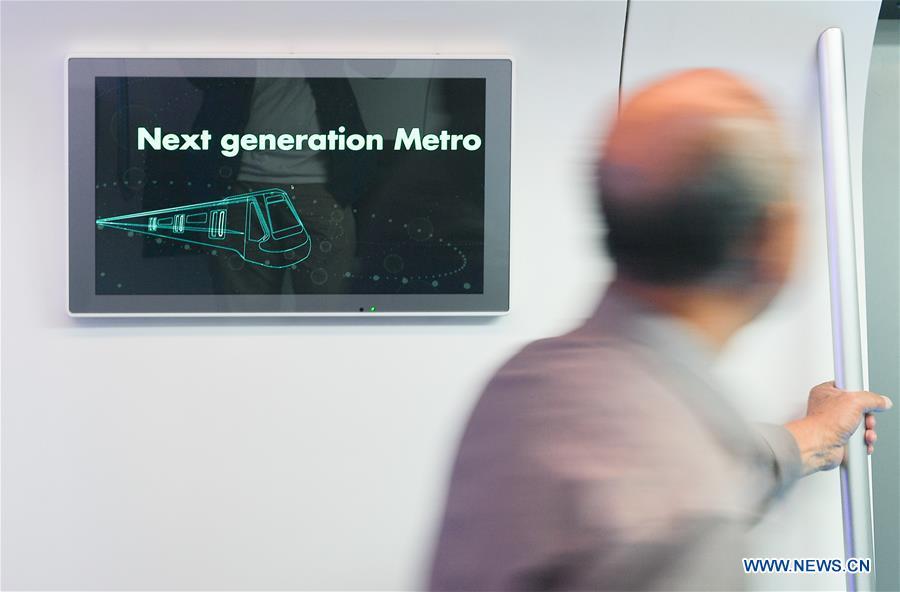 A man tries out a new-generation carbon-fiber light rail train at an exhibition held in Changchun, capital of northeast China\'s Jilin Province, Sept. 7, 2018. The body of the train is made of carbon fiber composite, making it more energy-efficient, according to its manufacturer CRRC Changchun Railway Vehicles Co., Ltd. (Xinhua/Xu Chang)