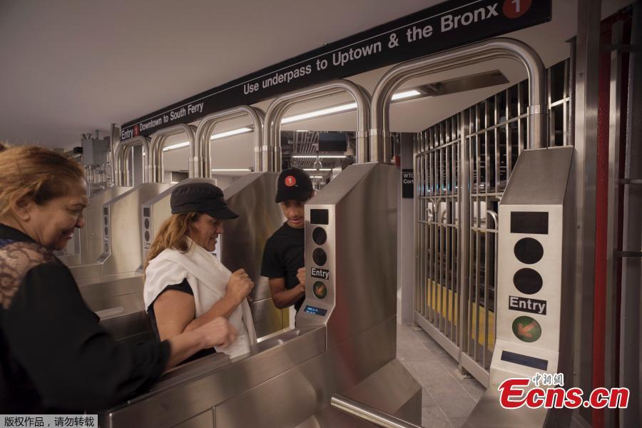 Passengers use a card to enter the newly-opened WTC Cortlandt subway station in New York, Sept. 8, 2018. The old Cortlandt Street station on the subway system\'s No. 1 line was buried under the rubble of the World Trade Center\'s twin towers on Sept. 11, 2001. Construction of the new station was delayed until the rebuilding of the surrounding towers was well under way. The new station cost $181 million and features a mosaic that uses words from the Declaration of Independence. (Photo/Agencies)
