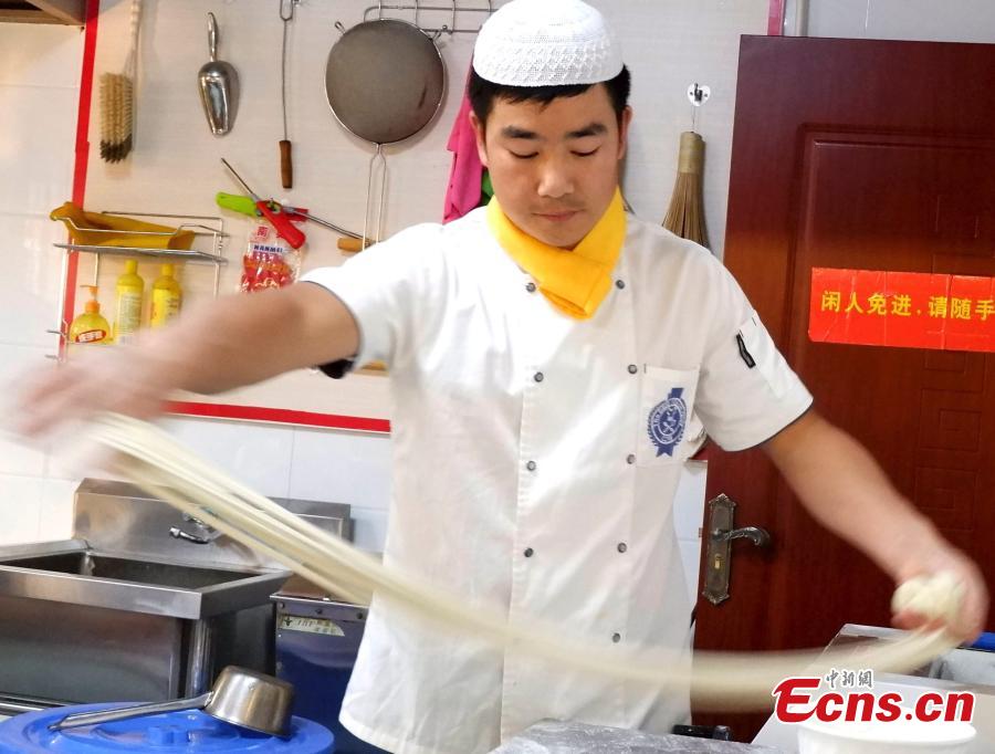 Mu Numa makes Lamian (hand-pulled noodles) in Hualong Hui Autonomous County, Northwest China’s Qinghai Province, Sept. 10, 2018. After years of practice, Ma is able to twist, stretch and fold the dough into strands thin enough to thread a needle. (Photo: China News Service/Li Juan)