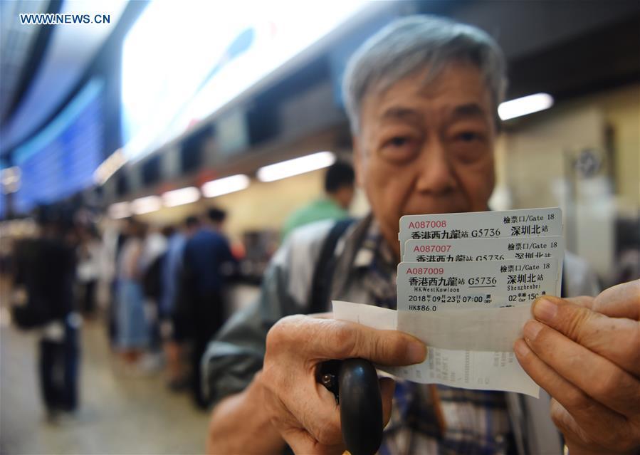 A passenger shows high-speed railway tickets from Hong Kong West Kowloon Station to Shenzhen North Station, in Hong Kong, south China, Sept. 10, 2018. The Guangzhou-Shenzhen-Hong Kong high-speed railway will officially start operation on Sept. 23. The sale of the tickets began on Monday. (Xinhua/Wang Shen)