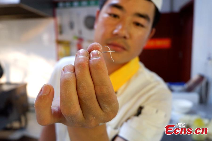 Mu Numa makes Lamian (hand-pulled noodles) in Hualong Hui Autonomous County, Northwest China’s Qinghai Province, Sept. 10, 2018. After years of practice, Ma is able to twist, stretch and fold the dough into strands thin enough to thread a needle. (Photo: China News Service/Li Juan)