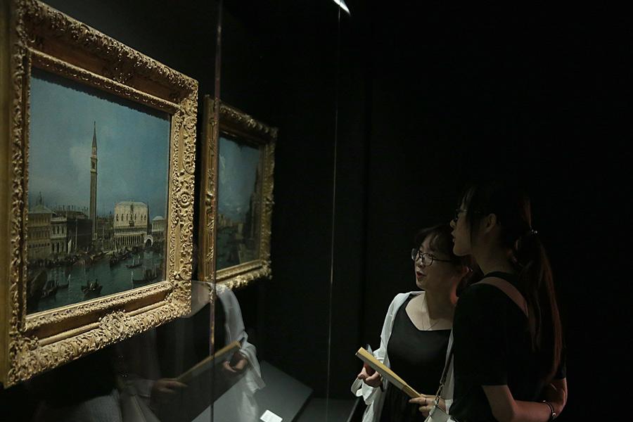 Visitors admire works by European artists. (Photo/China Daily)
Some exhibits also show the princes\' interest in China.

One of the books on display, which was published in 1665 and comes from the Library of the Prince\'s Palace in Monaco, plots the journeys made by the Dutch East India company in China.

During the 19th century, the focus of Monaco switched from agriculture to tourism as Monte Carlo developed as an entertainment destination. An old map in the exhibition shows the boundaries of Monaco at that time.

Fouilleron says one of the most important elements of this exhibition was to demonstrate the Grimaldis\' artistic tastes by displaying examples from their numerous collections of paintings.

Monaco has been generous enough to loan many works by iconic artists such as Titian, Monet, and Renoir, and the paintings were carefully selected for their connection to the principality.

For instance, visitors may feel that Monet enjoyed his trip to the country from his dreamlike touches in the 1884 canvasses Monte Carlo Seen from Roquebrune and The Bay of Monaco.

Of course, one name is unavoidable when talking about Monaco. Grace Kelly, the late Hollywood movie star and former princess of Monaco, has been given the privilege of having an entire section dedicated to her at the exhibition.

From her wedding gown, to her jewelry, costumes and even to her Oscar for winning best actress at the Academy Awards in 1954, Kelly\'s legendary lifetime of elegance both on and off screen, is recounted to visitors through a variety of exhibits.

The costume worn by Albert II, the current ruler of Monaco, on his wedding in 2011 and the tiara he gave to Princess Charlene, also lend a modern touch to the ancient architecture of the Meridian Gate.