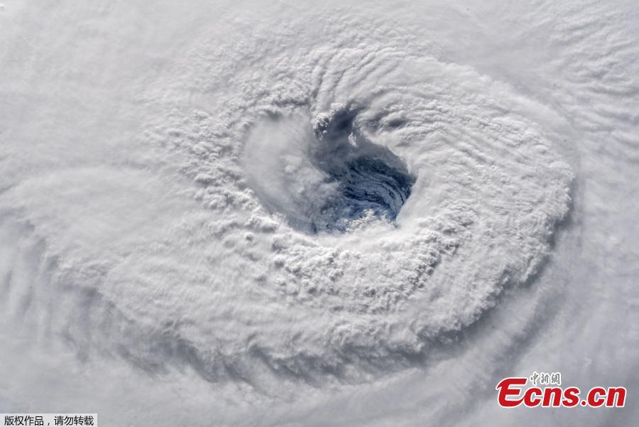 In this satellite image, Hurricane Florence churns through the Atlantic Ocean toward the U.S. East Coast, Sept. 12, 2018. Hurricane Florence, growing in size and intensity, crept closer to the U.S. East Coast on Wednesday as disaster mobilizations expanded south from the Carolinas into Georgia to counter the threat of fierce winds, deadly high seas and calamitous floods. (Photo/Agencies)