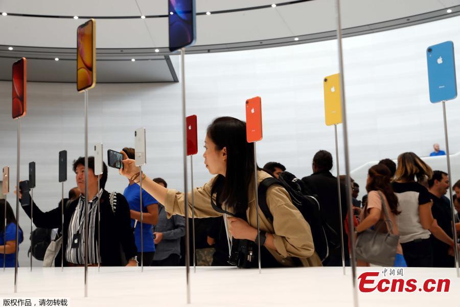 People take photos of the new Apple iPhones released following the product launch event at the Steve Jobs Theater in Cupertino, California, U.S. September 12, 2018.