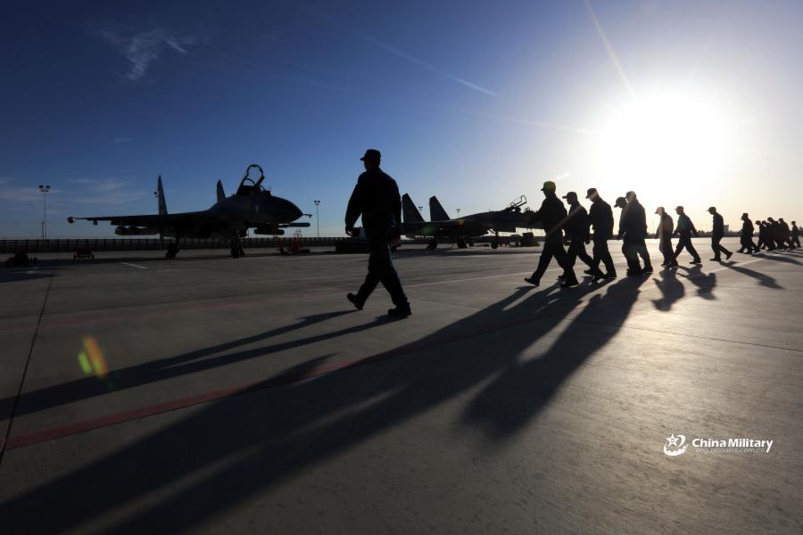Maintenance men assigned to an aviation brigade of the air force under the PLA Western Theater Command conduct a foreign object debris walk at a military airfield prior to the flight training exercise in the hinterland of the Kunlun Mountains in early September, 2018. (Photo/eng.chinamil.com.cn)