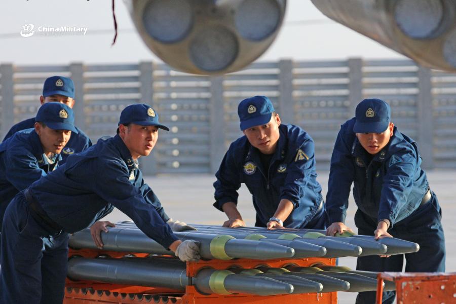 Weapons load crew airmen assigned to an aviation brigade of the air force under the PLA Western Theater Command transfer missiles of J-11 fighter jets prior to the flight training exercise in the hinterland of the Kunlun Mountains in early September, 2018. (Photo/eng.chinamil.com.cn)