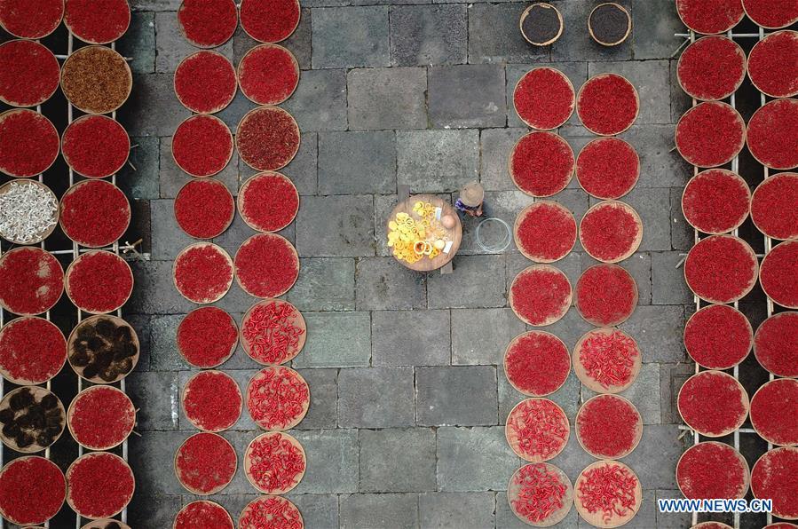 Aerial photo taken on Sept. 12, 2018 shows a villager airing crops at Chengkan Ancient Village in the city of Huangshan, east China\'s Anhui Province. (Xinhua/Shi Yalei)