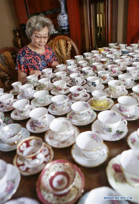 Teacup collector June Gao displays part of her teacup collections inside her house in Vancouver, Canada, Sept. 13, 2018. (Xinhua/Liang Sen)