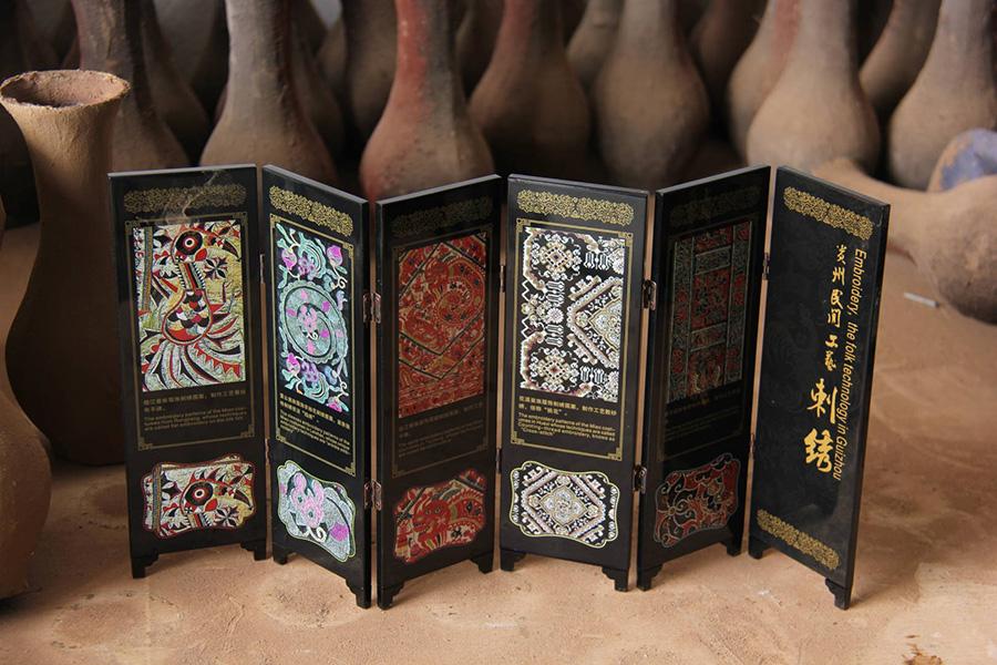 Lacquerware made in Dafang county, Guizhou Province has been known for its beauty. They are often moulded on a base of horse or buffalo skin, shaped after dipping in water, then dried over fire. This art form has been existed for over 600 years. (Photo/China Daily)
