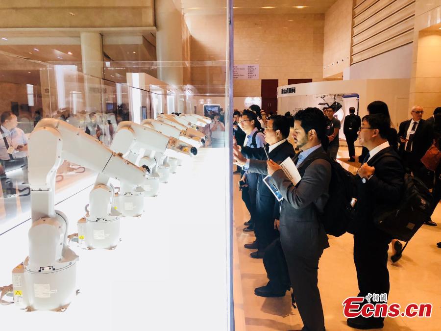 Visitors look at robots on display at Summer Davos at Meijiang Convention and Exhibition Center in Tianjin, Sept. 17, 2018. The Annual Meeting of the New Champions of the World Economic Forum (WEF), also known as Summer Davos, kicked off on Tuesday in Tianjin. This year\'s forum will feature a theme of \