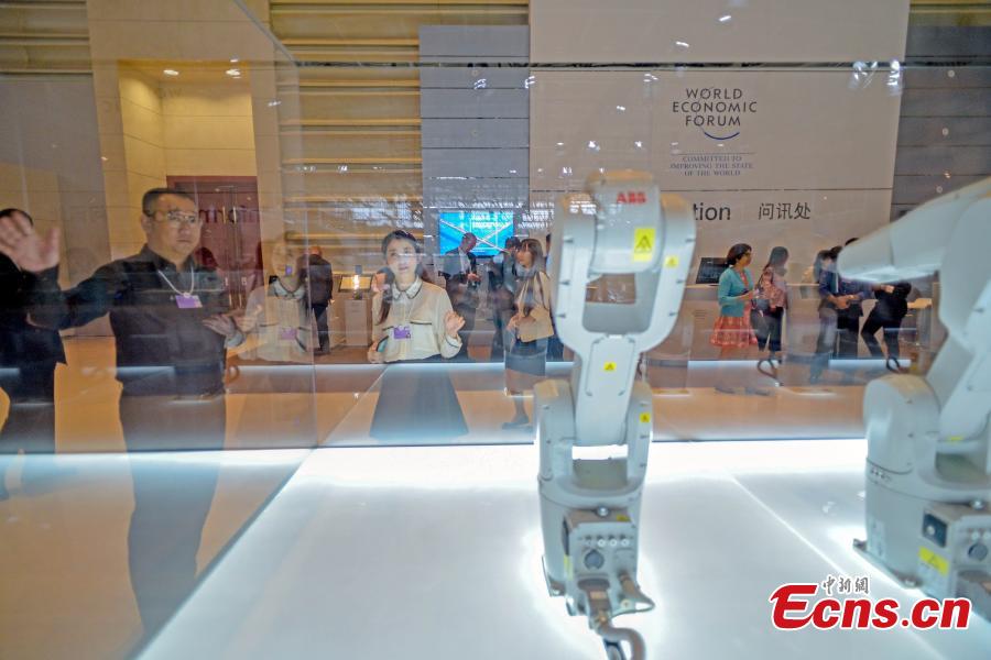 A visitor interacts with robot Manus at Summer Davos at Meijiang Convention and Exhibition Center in Tianjin, Sept. 17, 2018. The Annual Meeting of the New Champions of the World Economic Forum (WEF), also known as Summer Davos, kicked off on Tuesday in Tianjin. This year\'s forum will feature a theme of \
