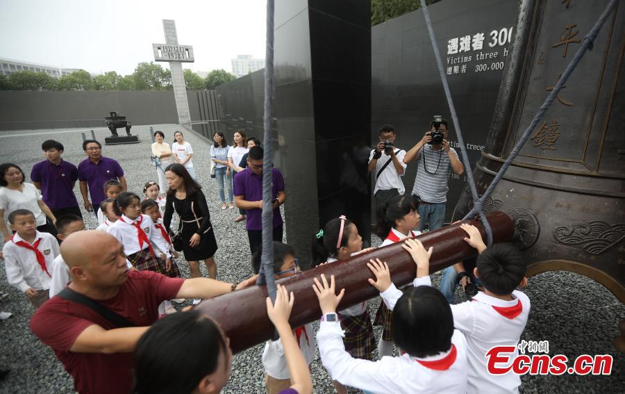 Visitors strike the Peace Bell at the Memorial Hall of the Victims in Nanjing Massacre by Japanese Invaders in Nanjing City, Jiangsu Province, Sept. 18, 2018. On September 18, 1931, the Japanese Kwantung Army stationed in northeast China destroyed a section of the railway near Liutiaohu and then falsely accused the Chinese military of causing the explosion. Using this as a pretext, the Japanese then bombarded Shenyang and began invasion of northeast China. (Photo: China News Service/Yang Bo)