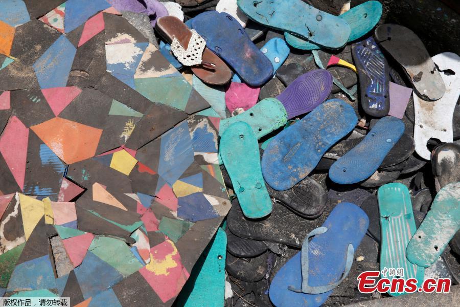 Flip-flops are seen on display before the launch ceremony of Flipflopi, the first dhow boat made entirely of recycled plastic on the island of Lamu, Kenya, Sept. 15, 2018. Kenyan islanders have built a boat made entirely of recycled plastic collected during clean-ups of the ocean to highlight the growing menace of plastic waste that ends up in the sea.(Photo/Agencies)
