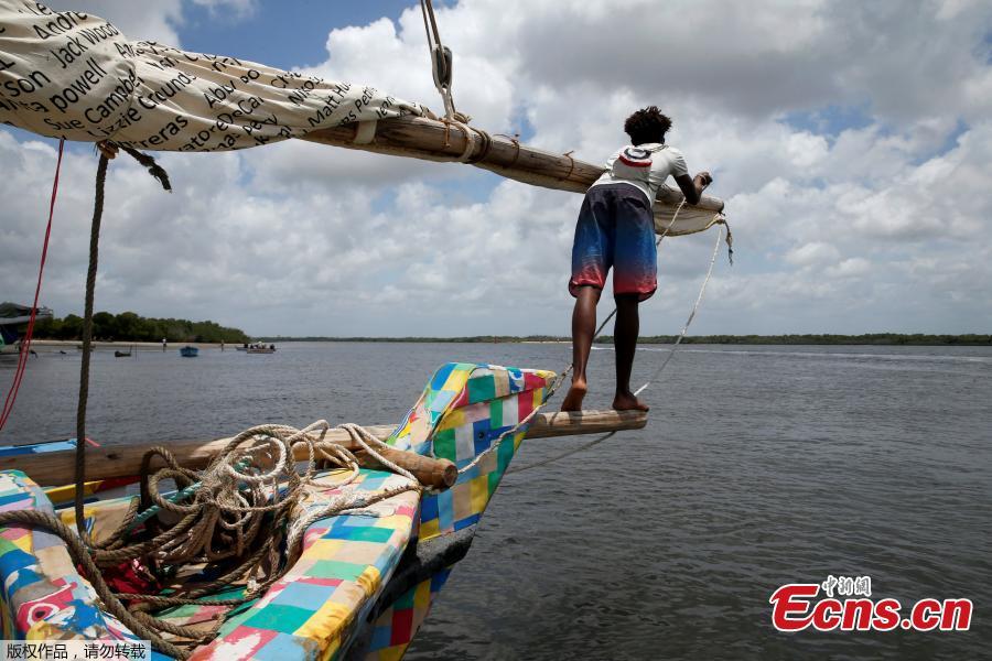 A man stands on the front of Flipflopi, the first dhow boat made entirely of recycled plastic before its launch ceremony on the island of Lamu, Kenya, Sept. 15, 2018. Kenyan islanders have built a boat made entirely of recycled plastic collected during clean-ups of the ocean to highlight the growing menace of plastic waste that ends up in the sea.(Photo/Agencies)
