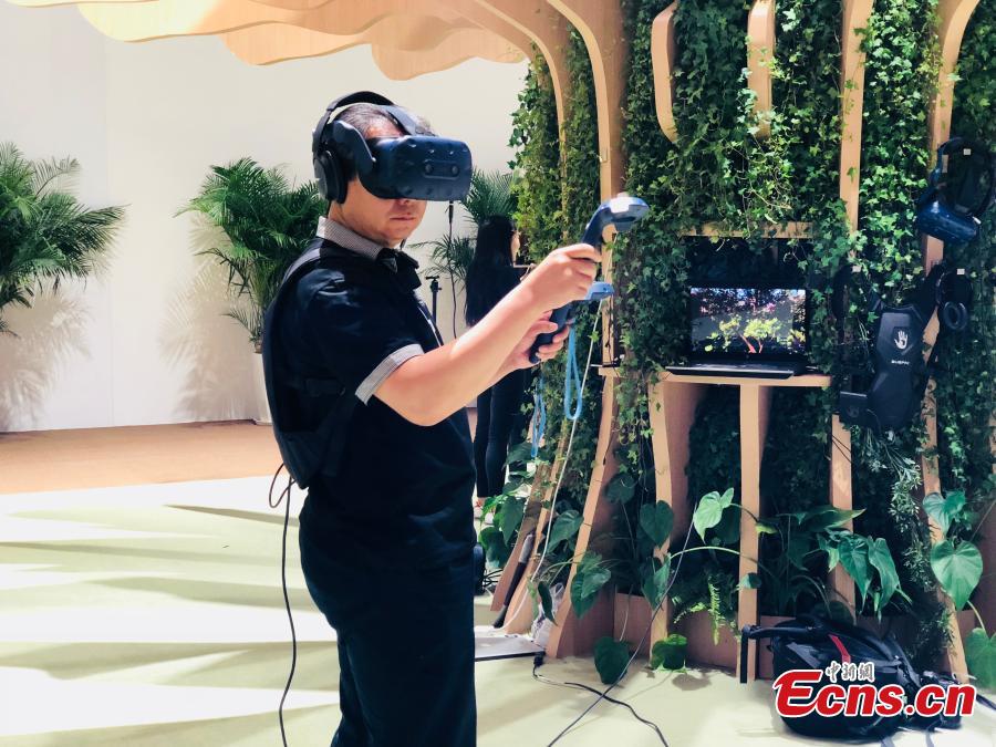 A man tests a simulator of virtual reality at Summer Davos at Meijiang Convention and Exhibition Center in Tianjin, Sept. 17, 2018. The Annual Meeting of the New Champions of the World Economic Forum (WEF), also known as Summer Davos, kicked off on Tuesday in Tianjin. This year\'s forum will feature a theme of \