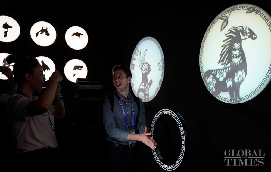 A visitor tries out an AI system that matches his hand gestures with a shadow puppet animal. (Photo: Yang Hui/GT)

Google AI technologies bring new experiences to visitors at the World Artificial Intelligence Conference on September 18.