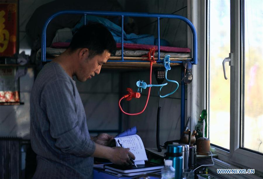 Forester Wang Liangcai keeps a record of reindeer feeding in Yue\'anli Forest Farm of Genhe forestry bureau in the Greater Khingan Mountains of north China\'s Inner Mongolia Autonomous Region, Sept. 18, 2018. Staff members at Yue\'anli Forest Farm are responsible for the conservation and breeding work of reindeer in China. (Xinhua/Zou Yu)