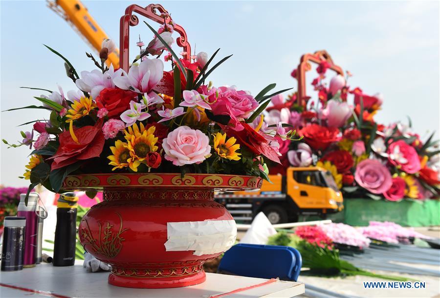 Artificial flowers are placed at the Tiananmen Square in Beijing, capital of China, Sept. 20, 2018. A 17-meter-tall installation in the shape of a flower basket with a diameter of 50 meters at the bottom is placed at the center of the Tiananmen Square as a decoration for China\'s upcoming National Day holiday. (Xinhua/Luo Xiaoguang)