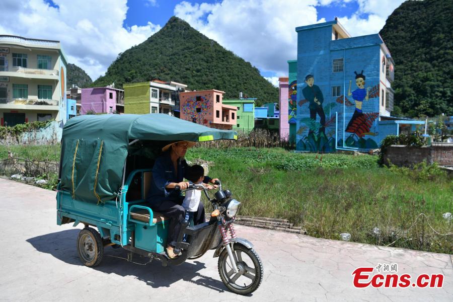 A view of the colorful buildings at Heye Village in Guangnan County, Southwest China’s Yunnan Province, Sept. 20, 2018. A group of artists began painting buildings and trees in different colors one month ago in order to help attract tourists to the village. (Photo: China News Service/Ren Dong)
