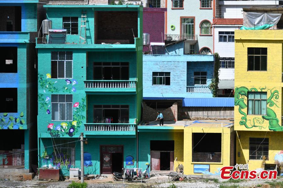 A view of the colorful buildings at Heye Village in Guangnan County, Southwest China’s Yunnan Province, Sept. 20, 2018. A group of artists began painting buildings and trees in different colors one month ago in order to help attract tourists to the village. (Photo: China News Service/Ren Dong)