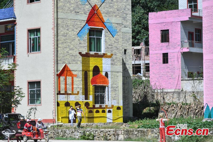 A view of the colorful buildings at Heye Village in Guangnan County, Southwest China’s Yunnan Province, Sept. 20, 2018. A group of artists began painting buildings and trees in different colors one month ago in order to help attract tourists to the village. (Photo: China News Service/Ren Dong)