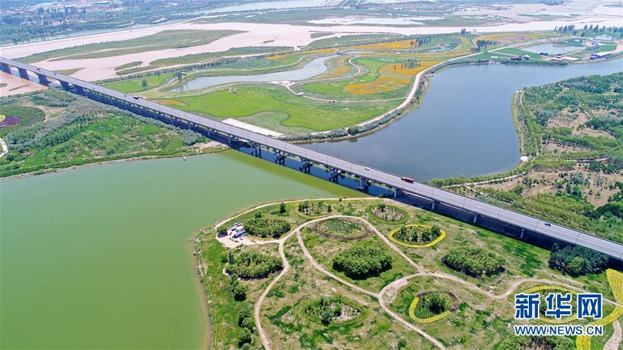 A photo taken June 26 shows a view of the Yellow River wetland park in Wuzhong city, Ningxia Hui autonomous region. (Photo/Xinhua)

The city has promoted ecological development through forestation, environmental restoration and major entry restrictions for companies that are highly polluting or consume a lot of energy.
