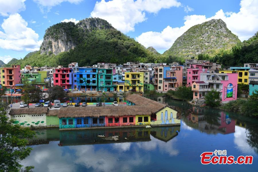 A view of the colorful buildings at Heye Village in Guangnan County, Southwest China’s Yunnan Province, Sept. 20, 2018. A group of artists began painting buildings and trees in different colors one month ago in order to help attract tourists to the village. (Photo: China News Service/Ren Dong)