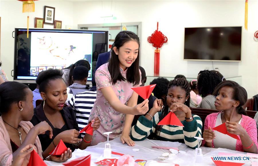 A Chinese volunteer teaches paper-cut at the Confucius Institute of the University of Nairobi, in Nairobi, Kenya, on Sept. 21, 2018. The Confucius Institute of University of Nairobi and the Confucius Institute of Kenyatta University held celebrations respectively on Friday to mark the upcoming Mid-Autumn Festival, which falls on Sept. 24 this year. (Xinhua/Wang Teng)