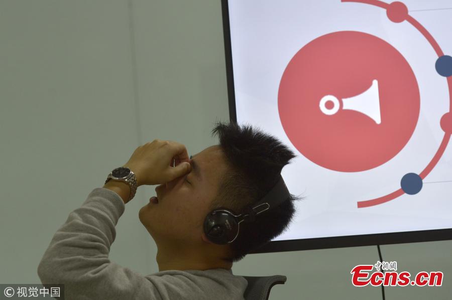 A man takes a break at an office where workers listen to thousands of audio files daily to clear audio porn from online platforms. The profession is dominated by young women, who listen to 4,000 pieces of audio and delete thousands of accounts in an average work day. People working in the sector say they rarely tell other people the exact nature of the work because of the stereotypes associated with identifying the obscene content. (Photo/VCG)