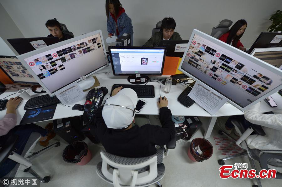 A view of an office where employees listen to audio materials in order to sift out pornographic material on audio social media platforms. The profession is dominated by young women, who listen to 4,000 pieces of audio and delete thousands of accounts in an average work day. People working in the sector say they rarely tell other people the exact nature of the work because of the stereotypes associated with identifying the obscene content. (Photo/VCG)