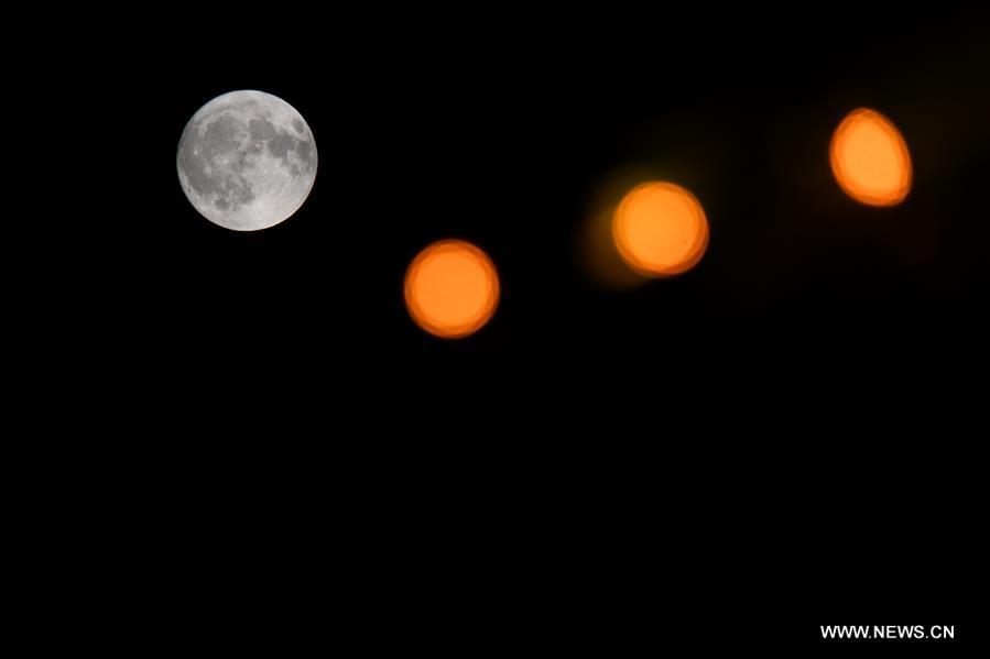 Photo taken on Sept. 24, 2018 shows the full moon at Nanhu park in Changchun, capital of northeast China\'s Jilin Province. The Mid-Autumn Festival, which falls on Sept. 24 this year, is a traditional Chinese festival with a custom of family reunion. (Xinhua/Zhang Nan)