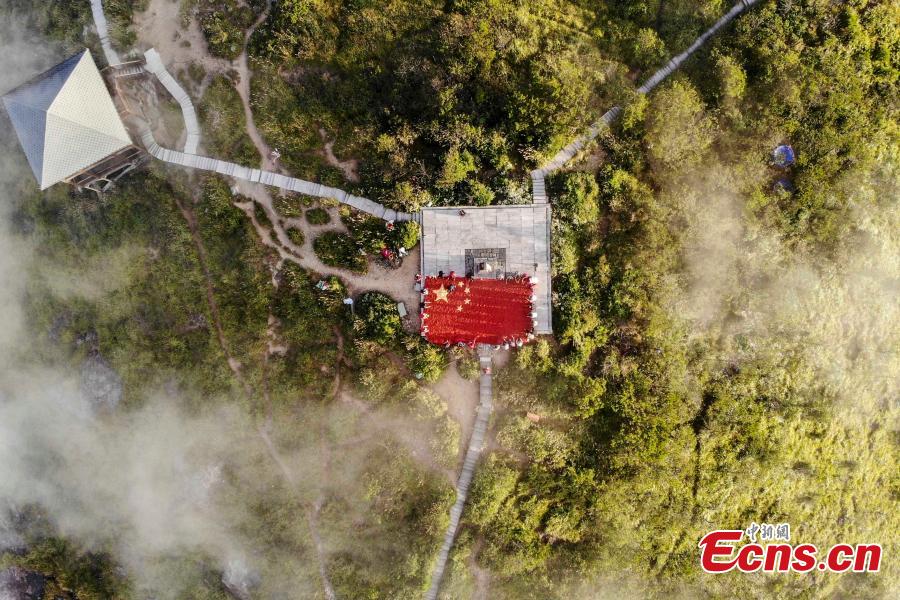 Farmers use eight tons of freshly-harvested peppers and corn to create a giant national flag on the top of Longquan Mountain in Zhejiang Province, Sept. 26, 2018, as part of harvest celebrations. The flag measured 10 meters in length and was 6.6 meters wide. The mountain is the highest peak in the Yangtze River Delta. (Photo: China News Service/Yang Yong)