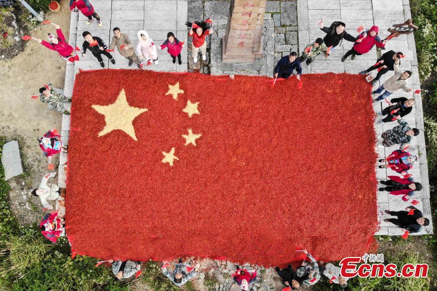 Farmers use eight tons of freshly-harvested peppers and corn to create a giant national flag on the top of Longquan Mountain in Zhejiang Province, Sept. 26, 2018, as part of harvest celebrations. The flag measured 10 meters in length and was 6.6 meters wide. The mountain is the highest peak in the Yangtze River Delta. (Photo: China News Service/Yang Yong)