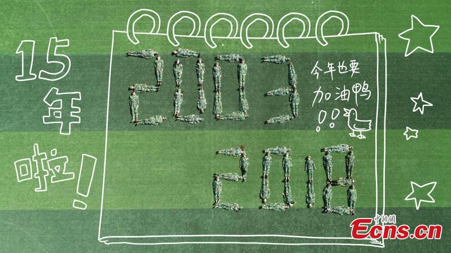 Drone photos show freshmen students of Fujian Normal University posing to form different patterns to mark their military training experience in Fuzhou City, East China’s Fujian Province. A total of 128 students lied on the ground or stood up to form numbers, Chinese characters and images in the creation. (Photo: China News Service/Chen Kekan)