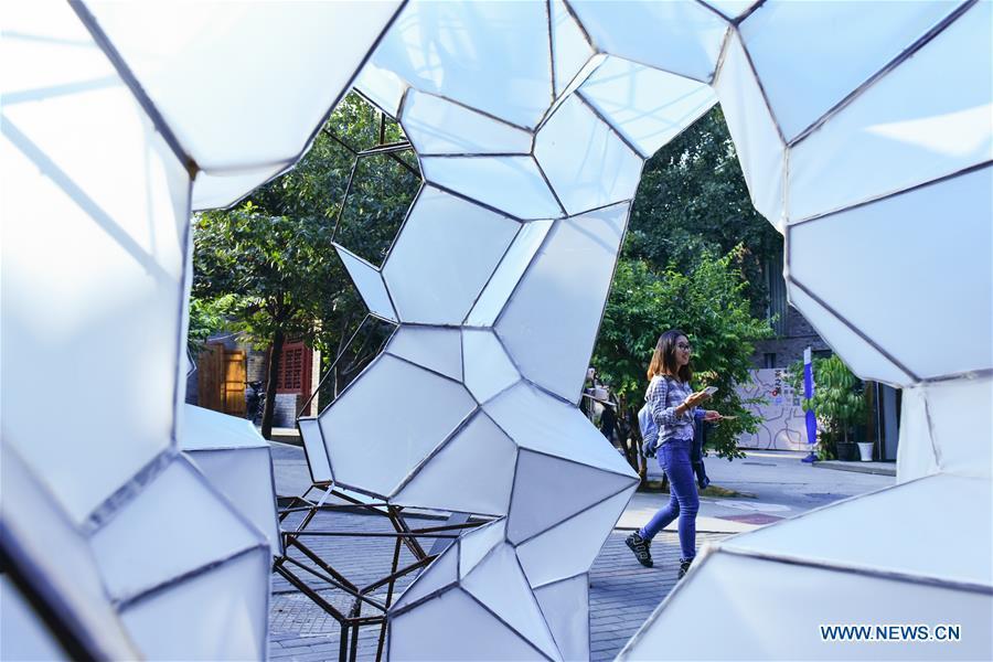 A visitor walks past a decoration art work displayed at the Beijing Design Week in Beijing, capital of China, Oct. 4, 2018. The Beijing Design Week, a platform aimed at promoting the concept of a sustainable development of creative and design industry, last from Sept. 22 to Oct. 7. (Xinhua/Li Mangmang)
