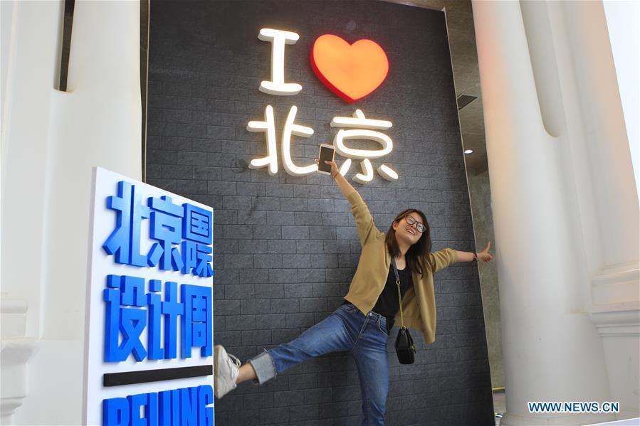 A woman poses for photos at the Beijing Design Week in Beijing, capital of China, Oct. 4, 2018. The Beijing Design Week, a platform aimed at promoting the concept of a sustainable development of creative and design industry, last from Sept. 22 to Oct. 7. (Xinhua/Sui Xiankai)