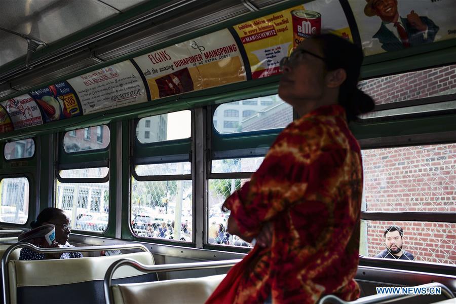 A woman views the interior of Bus 3100, one of the first air-conditioned buses to debut in the United States when it was tested in 1956, during the 25th Annual Bus Festival in New York, the United States, on Oct. 7, 2018. The New York Transit Museum held its 25th annual bus festival on Sunday. The buses on display represent about 80 years of surface transit history in New York City. The oldest bus at the festival, Bus 1263, is a double-decker bus that was purchased by the Fifth Avenue Bus Company in 1930. (Xinhua/Li Muzi)